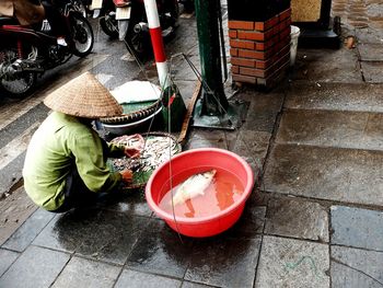 High angle view of vendor with fish at market