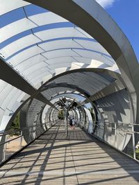Low angle view of people on footbridge