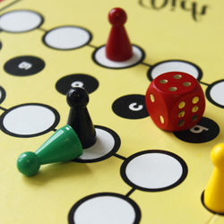 Close-up of game pieces and dice on ludo