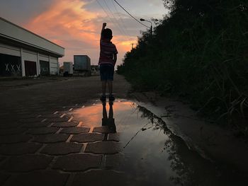 Reflection of man in puddle