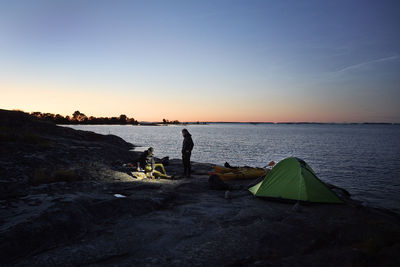 View of tourist camping at sea at sunset