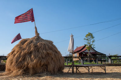 Built structure on field against sky