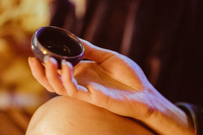 Close-up of hand holding coffee cup