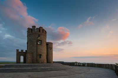 Old building against sky during sunset