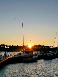 Sailboat in sea at sunset