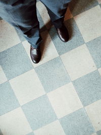 Low section of person on tiled floor