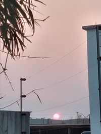 Low angle view of street light against sky during sunset