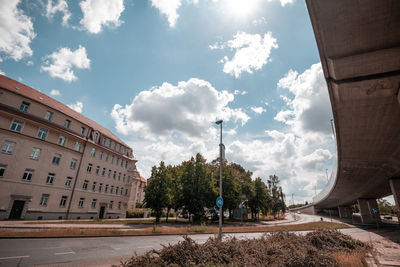 Low angle view of buildings and trees against sky