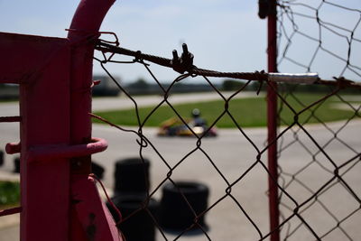 Close-up of chainlink fence against sky