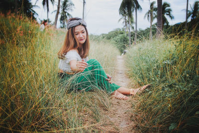 Portrait of woman sitting on field