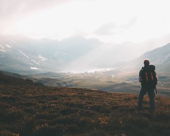 Rear view of hiker looking at mountains