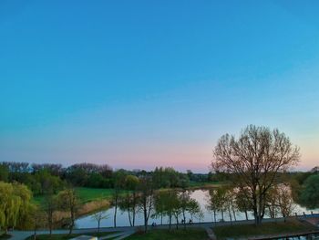 Scenic view of lake against clear blue sky