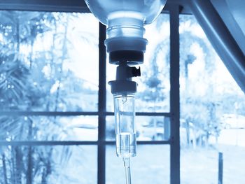 Close-up of iv drip against window