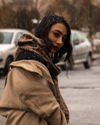 Portrait of young woman standing outdoors