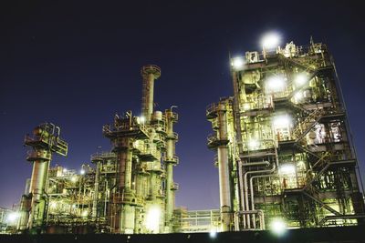 Low angle view of illuminated buildings against sky at night