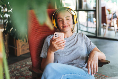 Portrait of teenage girl sitting on mobile phone