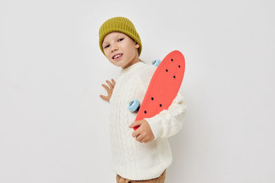 Portrait of girl holding skateboard