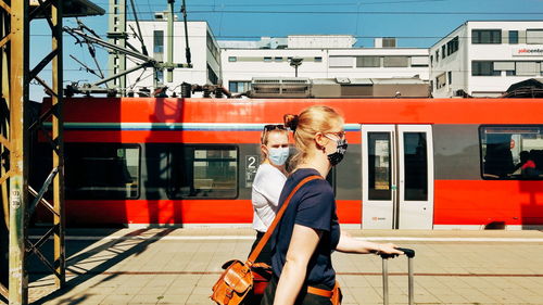 Full length of woman with train at railroad station