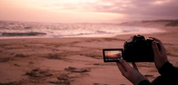 Man photographing at sunset