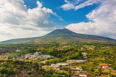 Scenic view of townscape and mountains against sky