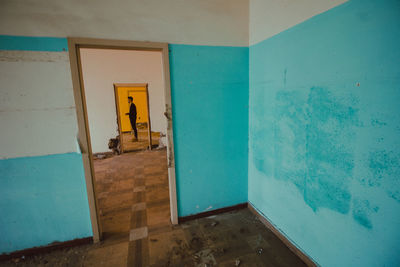 Full length of man standing in abandoned house