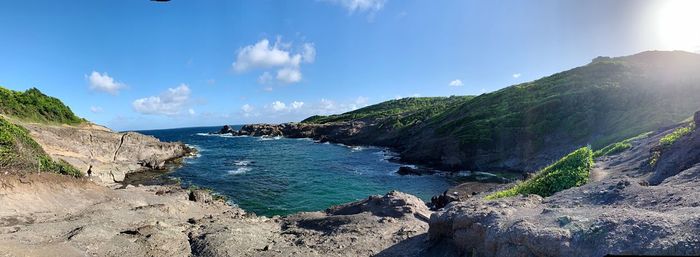 Panoramic view of sea and mountains against sky