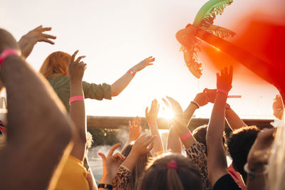 Rear view of young men and women enjoying in music concert