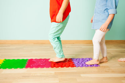 Low section of people standing on wooden floor