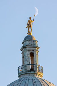 Statue on the top of the rhode island capitol building with the moon