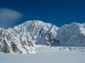 Scenic view of mountains against clear blue sky