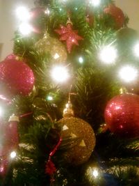 Low angle view of christmas tree at night