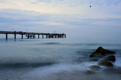 Pier over sea against sky