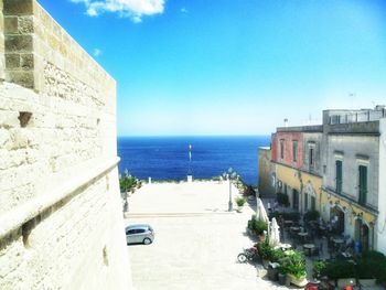 Panoramic view of sea and buildings against sky