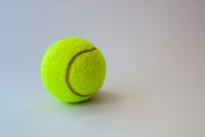 Close-up of tennis ball on white background
