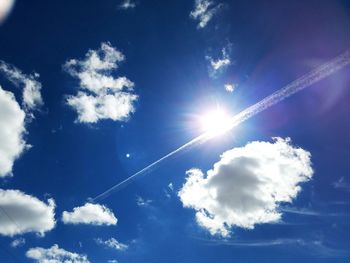 Low angle view of vapor trail against blue sky