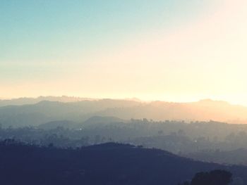 Scenic view of silhouette mountains against sky at sunset