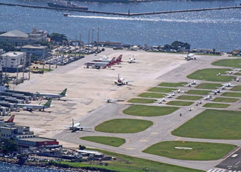 High angle view of city by sea against sky