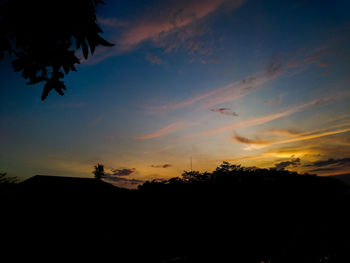 Low angle view of silhouette trees against sky during sunset