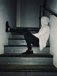 Side view of man sitting on bench