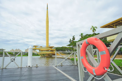 Information sign by swimming pool in river against building