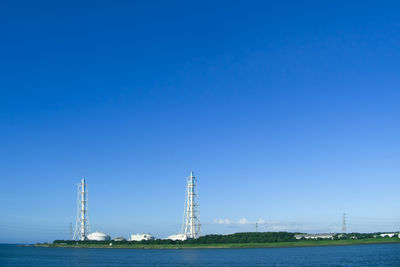 Bridge over river against clear blue sky