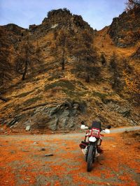 Motorcycle parked against mountain during autumn