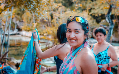 Portrait of smiling woman in swimwear standing outdoors