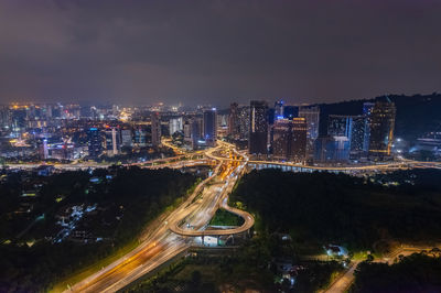 High angle view of illuminated buildings in city at night