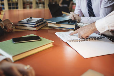 Cropped image of lawyers at table in meeting