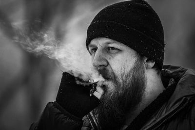 Portrait of man smoking cigarette