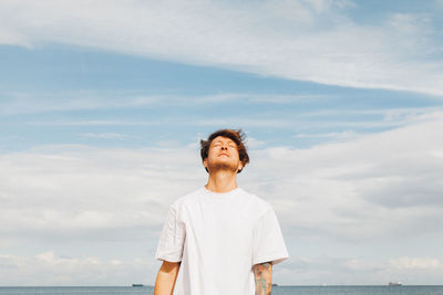 Man standing by sea against sky