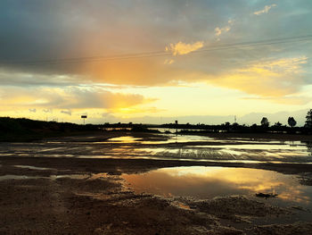 Scenic view of lake against sky during sunset