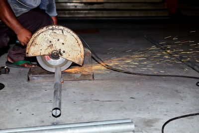 A worker use a sliding compound mitre saw with circular blade for cutting