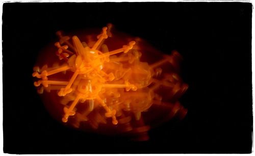 Close-up of illuminated candle against black background